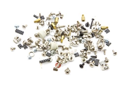 Various screws scattered on a white background