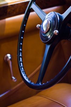 Closeup on vintage car steering wheel, interior retro oldtimer