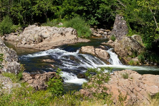 Landscape with little waterfall in the river