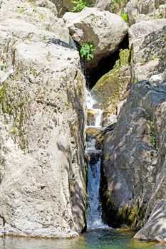 Landscape with little waterfall in the river between rocks