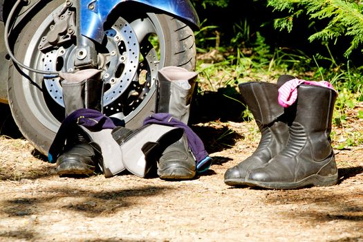Pair of boots next to motorcycle in closeup