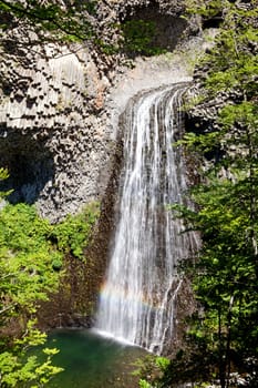 Cascade of Ray Pic France with rainbow, famous waterfall in Ardeche 