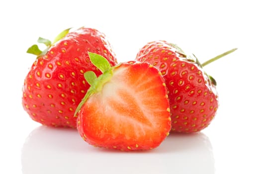 Couple of fresh strawberries in closeup over white background