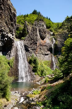 Cascade of Ray Pic France with rainbow, famous waterfall in Ardeche