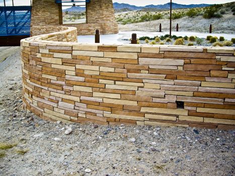 Curved wall of sandstone at bridge entrance