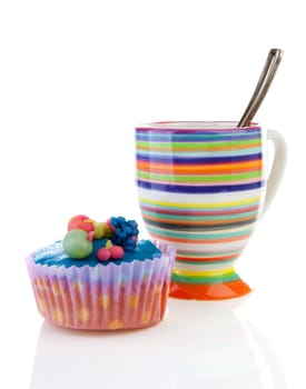 Decorated colorful cupcake and cup of coffee over white background