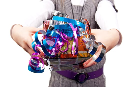 Child is giving present; hands with gift and streamers over white background