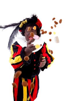 Zwarte piet ( black pete) typical Dutch character part of a traditional event celebrating the birthday of Sinterklaas in december over white background throwing pepernoten ( ginger nuts) 
