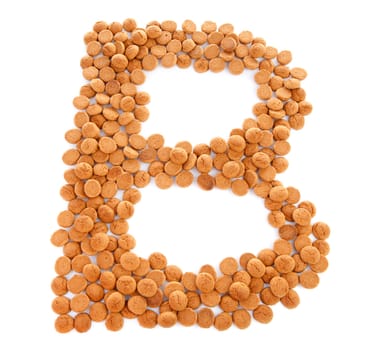 Ginger nuts, pepernoten, in the shape of letter B isolated on white background. Typical Dutch candy for Sinterklaas event in december