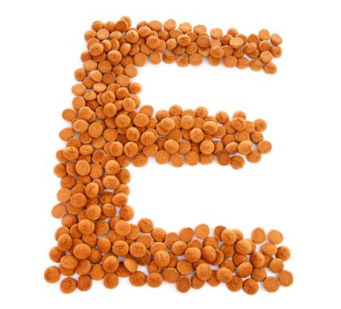 Ginger nuts, pepernoten, in the shape of letter E isolated on white background. Typical Dutch candy for Sinterklaas event in december