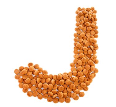 Ginger nuts, pepernoten, in the shape of letter J isolated on white background. Typical Dutch candy for Sinterklaas event in december