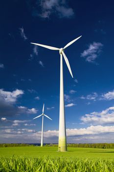 Windmills against a blue sky and clouds, alternative energy source