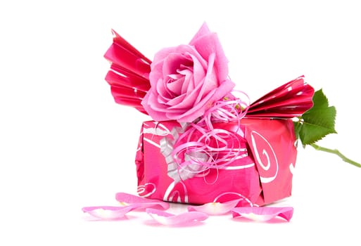 Beautiful wrapped gift with rose for birthday or valentine's day over white background
