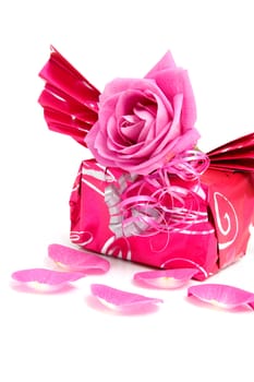 Beautiful wrapped gift with rose for birthday or valentine's day over white background