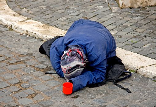 Poor woman on the street begging for money