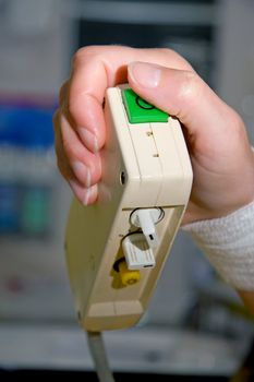 a patient's hand is pushing the nurse call button in hospital