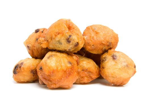 Pile of Dutch donut also known as oliebollen, traditional New Year's eve food isolated on white background
