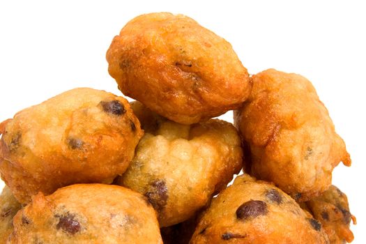 Pile of Dutch donut also known as oliebollen, traditional New Year's eve food isolated on white background