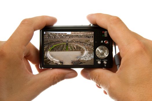 Photo camera in hands taking picture of the inside of colosseum in Rome isolated on white background