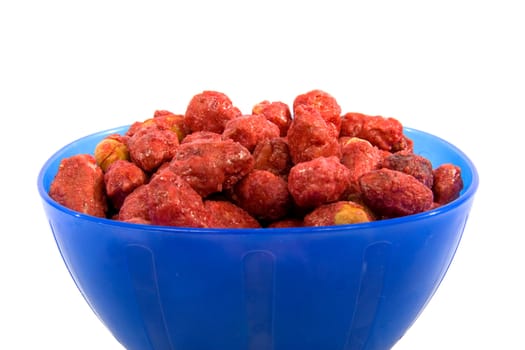 Blue bowl with sugared peanuts over white background