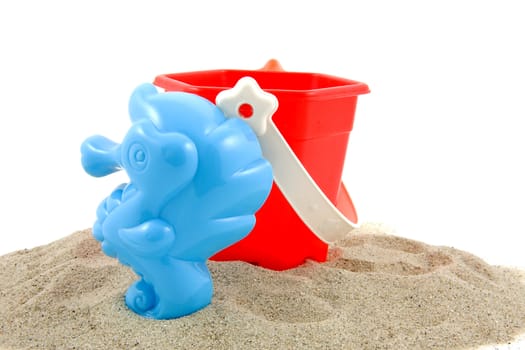 plastic play toys for at the beach over white background