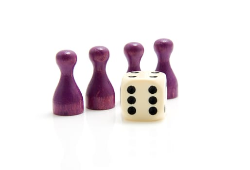 Four purple wooden pawns with dice over white background