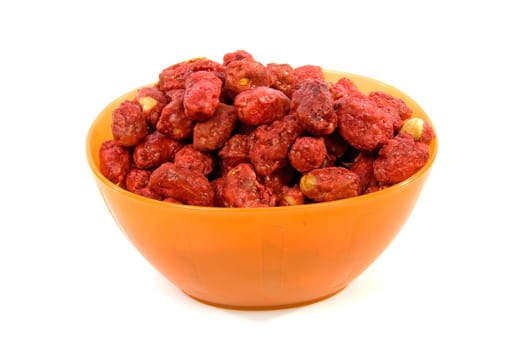 Orange bowl with sugared peanuts over white background