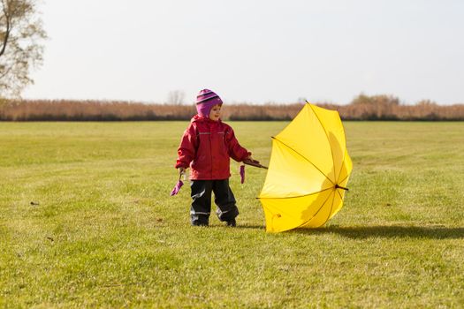autumn child portrait with yellow umbrella