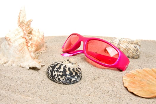 Pink sunglasses on the beach over white background