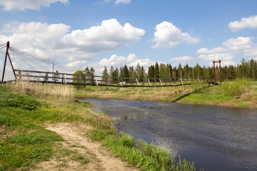Suspended wooden bridge over a river 