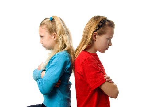 Two young blonde girls are angry at each other over white background