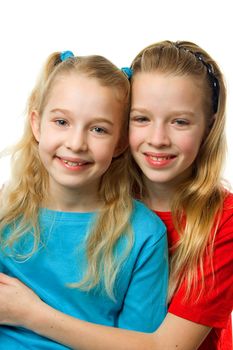 portrait of two young blonde girls looking in camera over white background