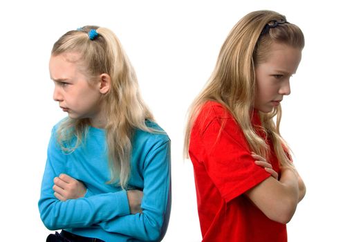 Two young blonde girls are angry at each other over white background