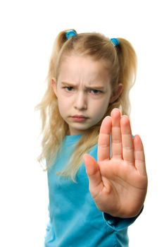 one caucasian girl is making stop sign with hand, sharp on hand and blur on girl, over white background