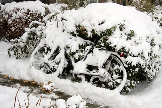 bicycle burried onder the snow, it's winter time
