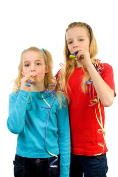 Two birthday girls with noisemaker over white background