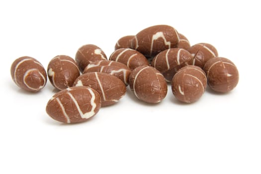 Pile of chocolate easter eggs over white background