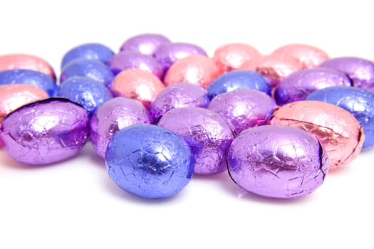 colorful chocolate easter eggs in closeup over white background
