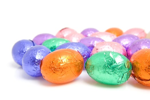 colorful chocolate easter eggs over white background