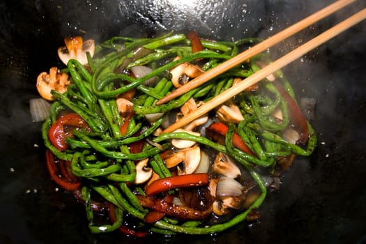 preparing dinner with long green beans in wok pan