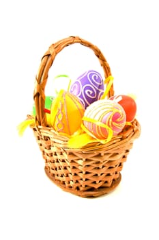 Basket with colorful easter eggs over white background