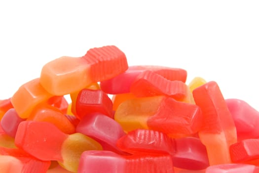 Pile of colorful sweet candy in closeup over white background