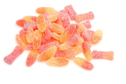 Pile of colorful sugar candy in closeup over white background