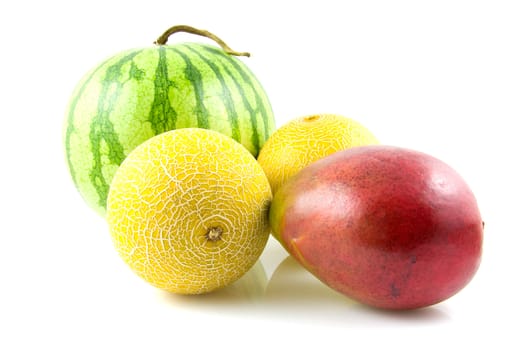 Fresh mango and melon fruits over white background