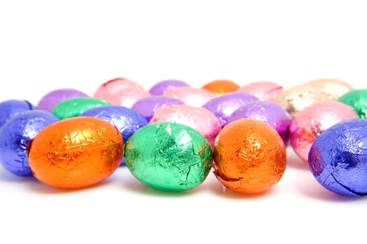 colorful chocolate easter eggs over white background