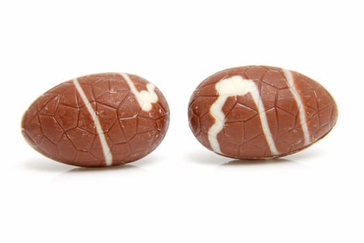 two chocolate easter eggs over white background