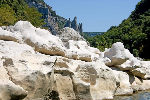 Rocks in the Ardeche of France with view of the famous cathedral in the back.