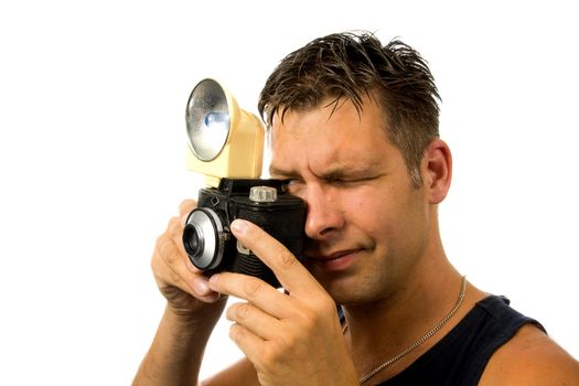 man is taking pictures with old fashioned photo camera over white background