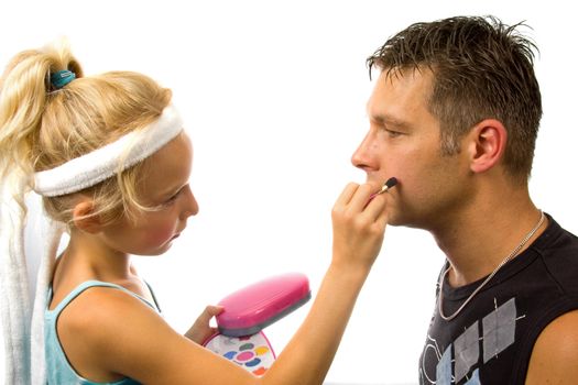 Little blonde girl is putting makeup on by her father over white background