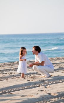 happy family father and daughter on beach having fun summer vacation